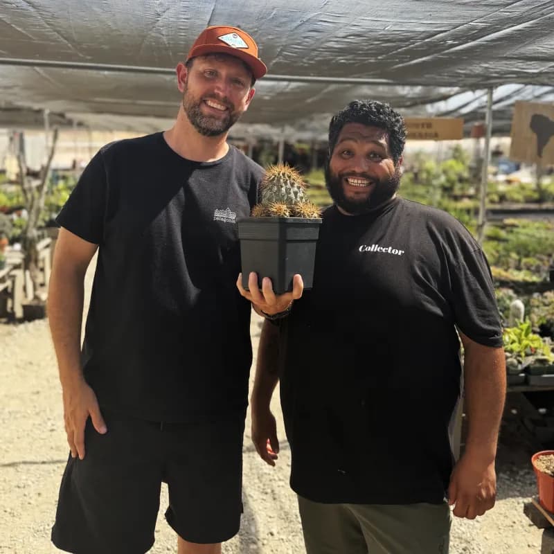 Brian holding a freshly purchased cactus alongside Oscar at Green Touch Nursery